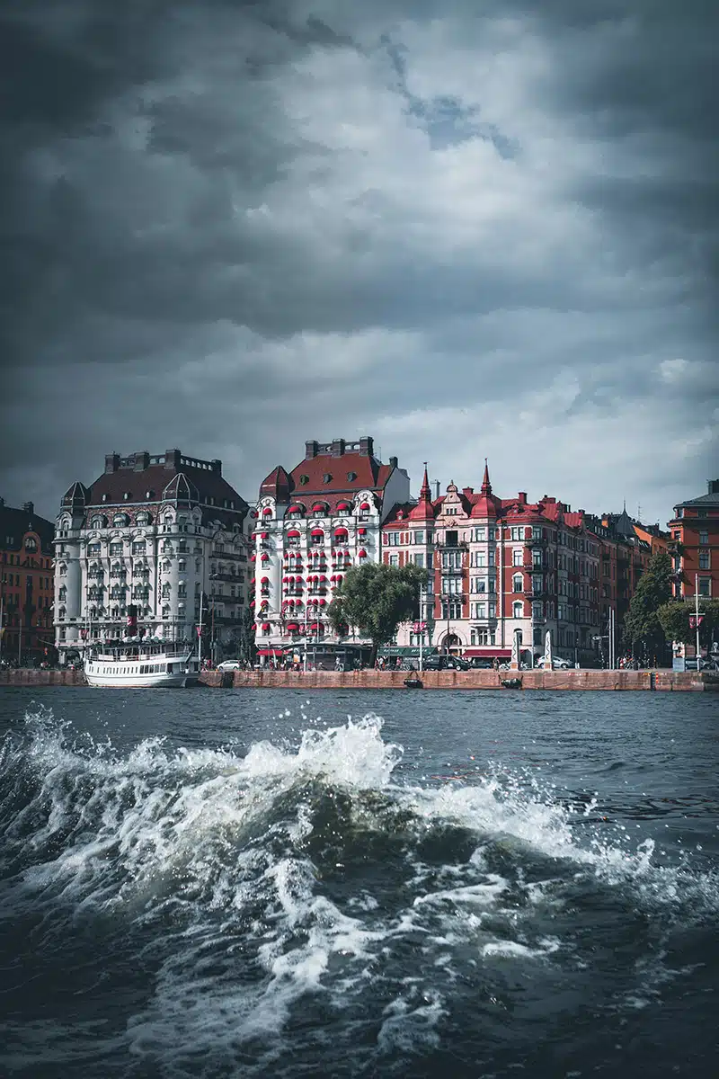 Wellengang vor dem Hafen in Stockholm. Im Hintergrund sind Häuser.