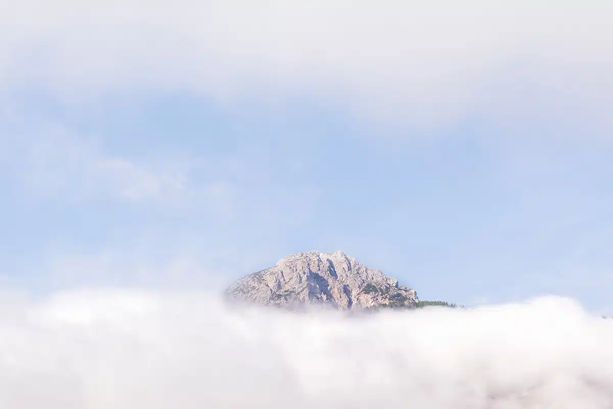 Eine Bergspitze in den Wolken.